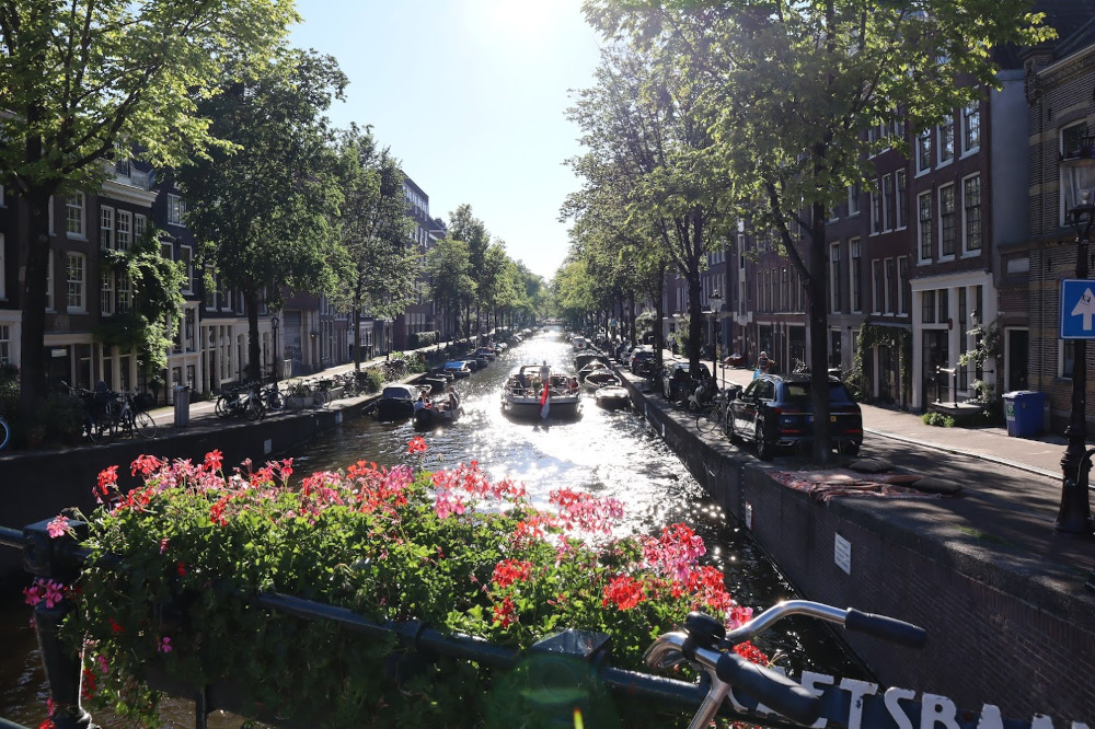 A boat sets forth in one of the canals of Amsterdam.