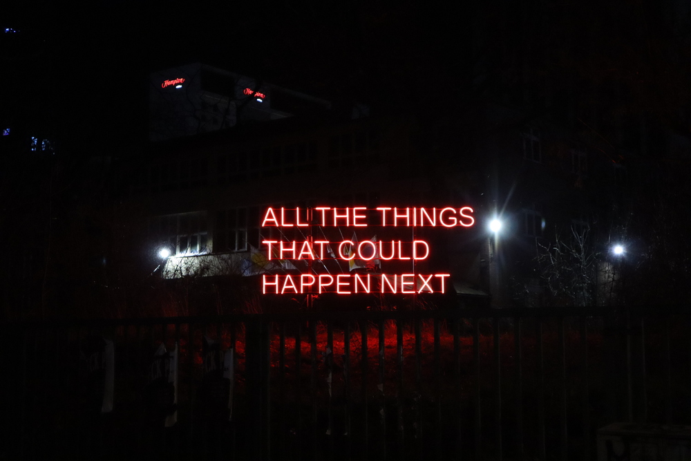 An illuminated sign in Warsaw saying "All the things that could happen next".